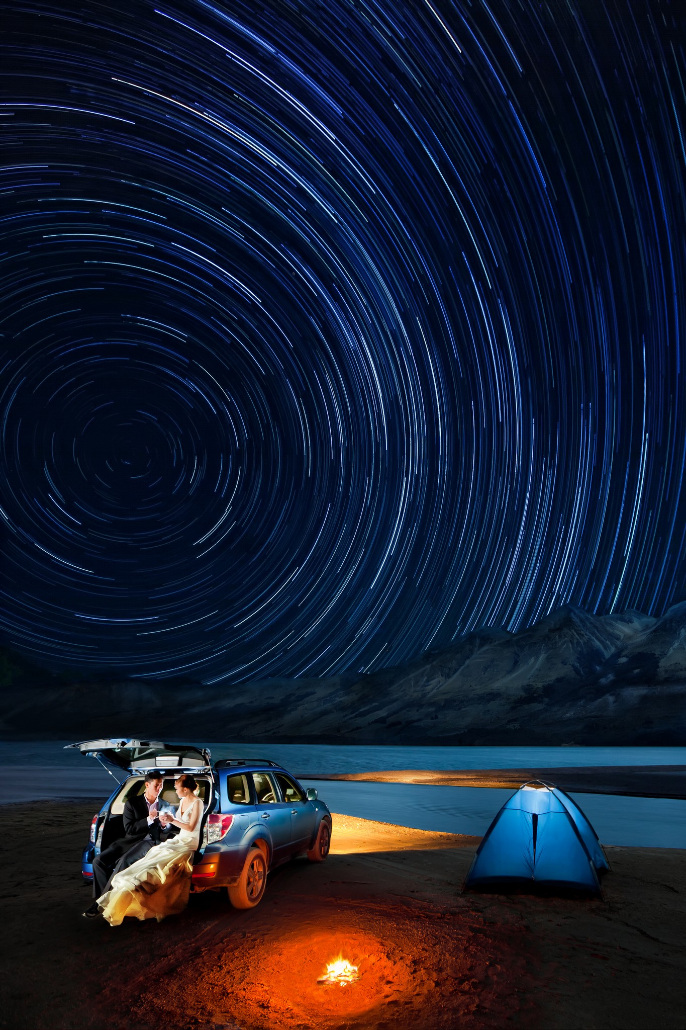 A car and tent on the beach under a starry sky, perfect for creative wedding photography.