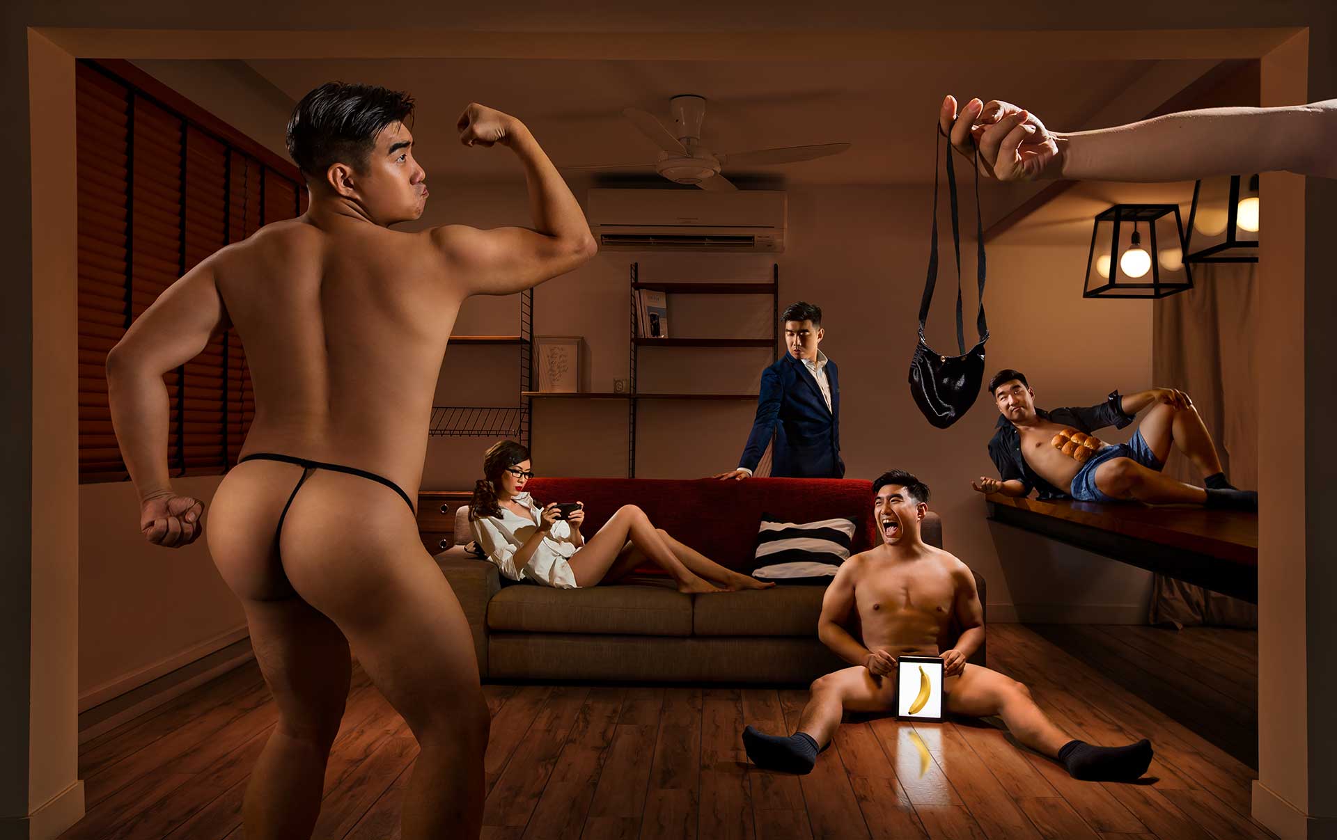 A man in underwear confidently poses in front of a group of people in a funny and creative photoshoot.