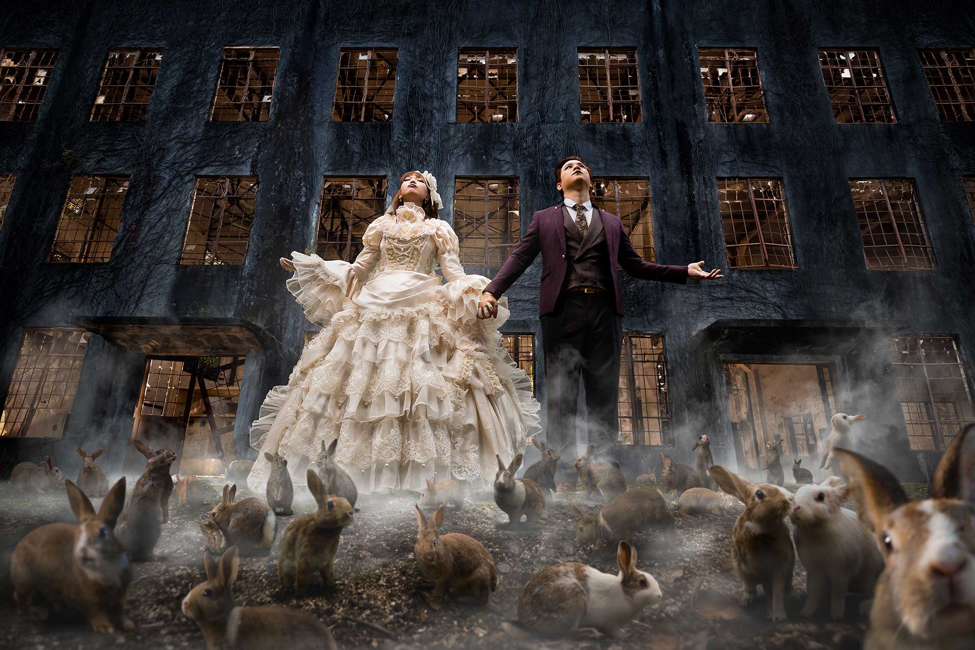 A Victorian couple posing with a group of rabbits in a creative wedding photoshoot.